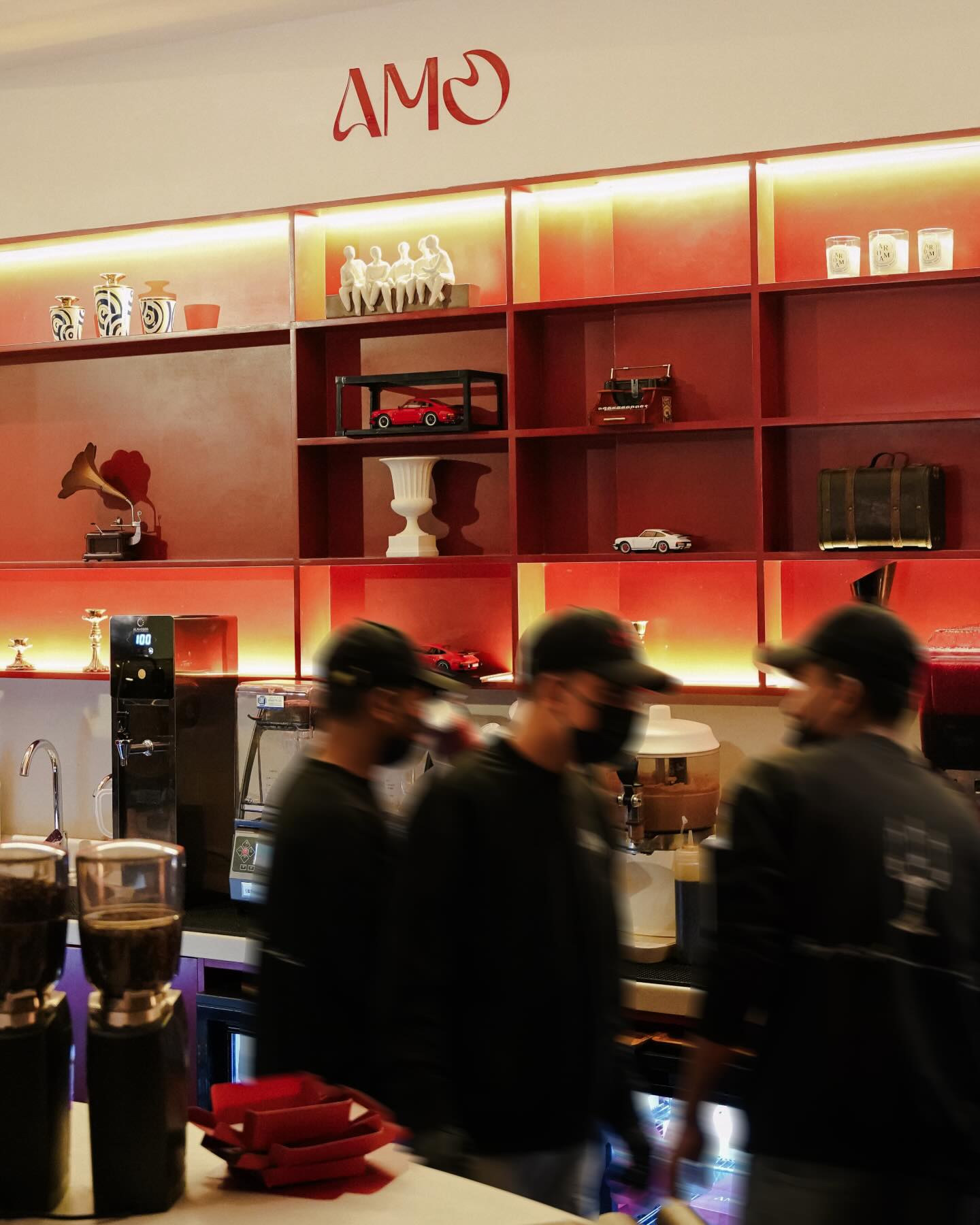 AMO coffee bar with burgundy shelves and team